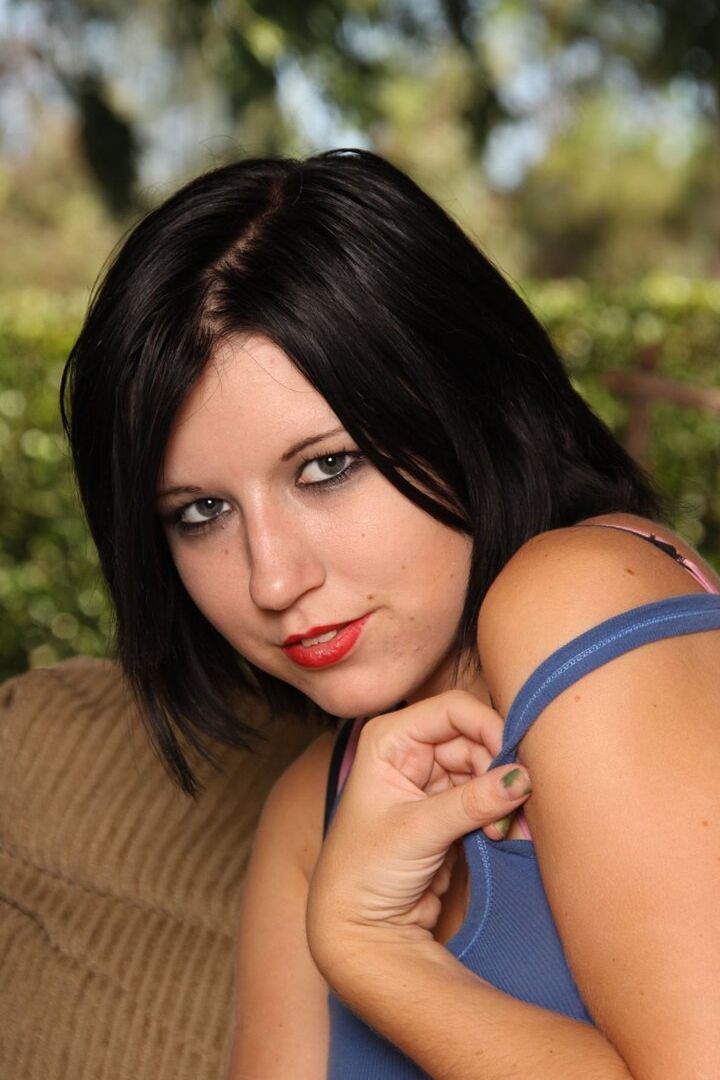 16P Dark haired amateur Torrid sports red lips while getting buck naked on a sofa