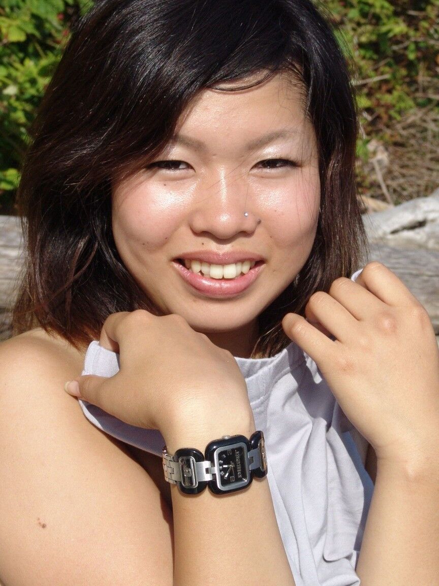 16P Asian amateur Sugar slips spandex pants over her ass while smoking on a beach