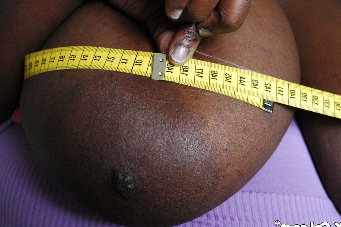 21P Curvy amateur ebony Mariana Kodjo displays her huge saggy tits in a solo