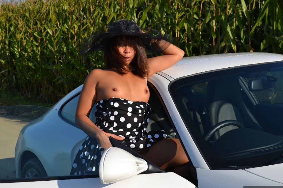 20P Asian amateur gets naked on top of a car while wearing a big hat