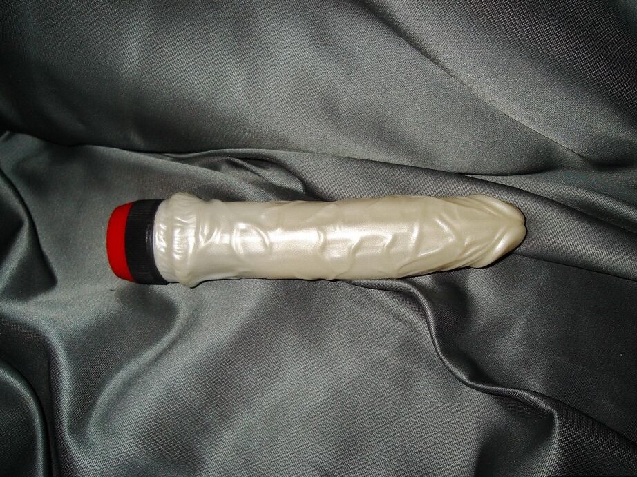 20P Busty redhead masturbates with a vibrator while draped in chains