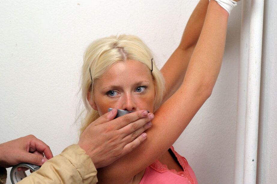 12P Clothed blonde is shut up with duct over mouth and wrists tied together