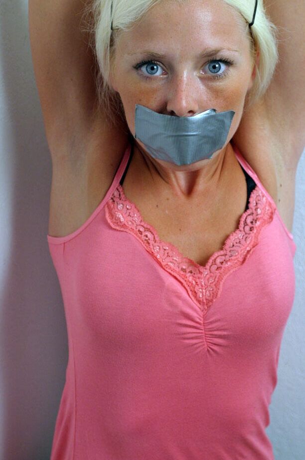 12P Clothed blonde is shut up with duct over mouth and wrists tied together