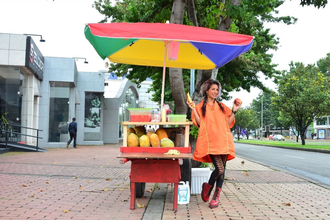 17P Beautiful Colombian fruit seller gestures provocatively with a banana