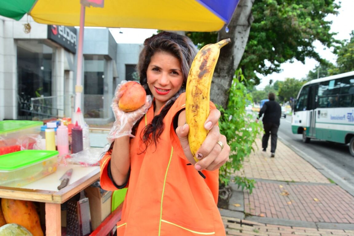 17P Beautiful Colombian fruit seller gestures provocatively with a banana