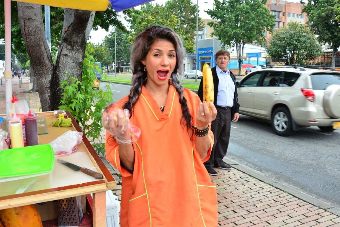 17P Beautiful Colombian fruit seller gestures provocatively with a banana