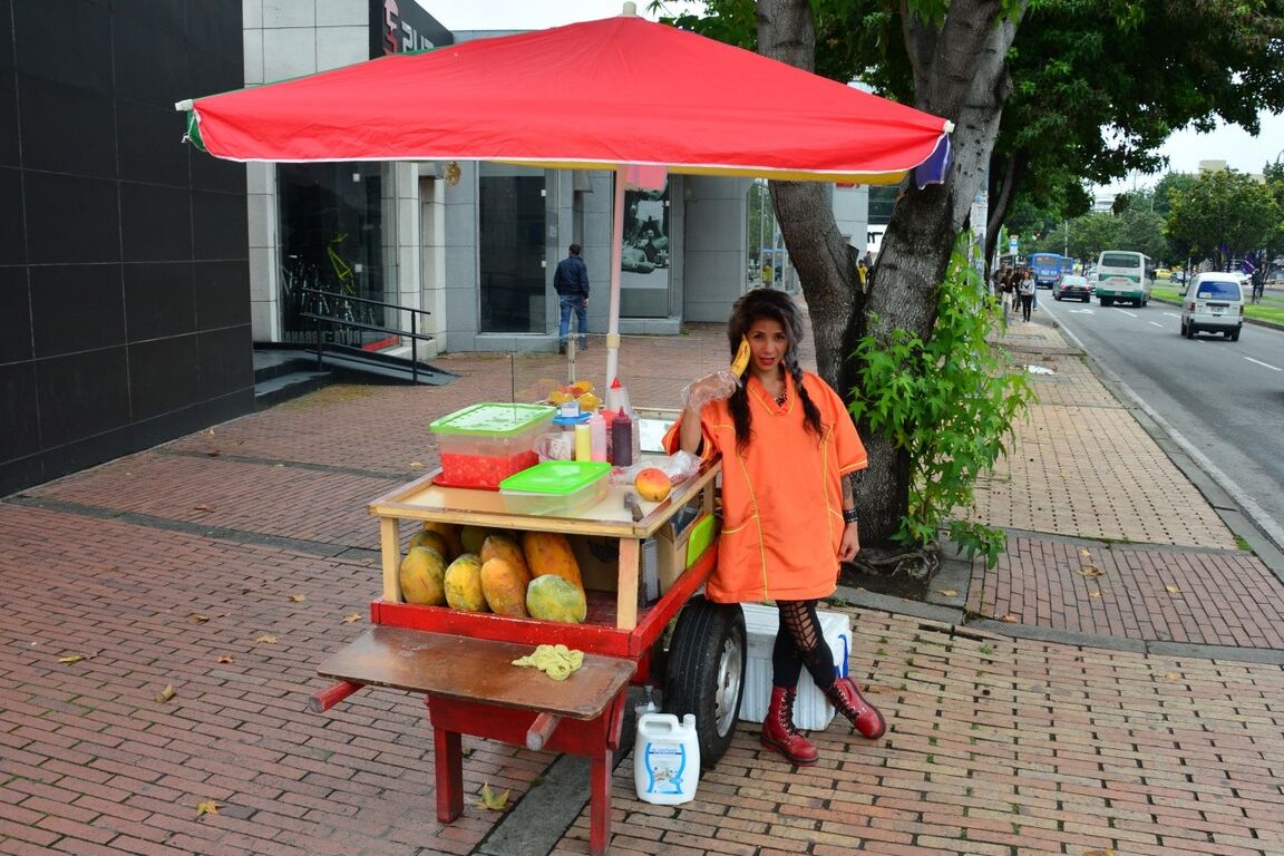 17P Beautiful Colombian fruit seller gestures provocatively with a banana