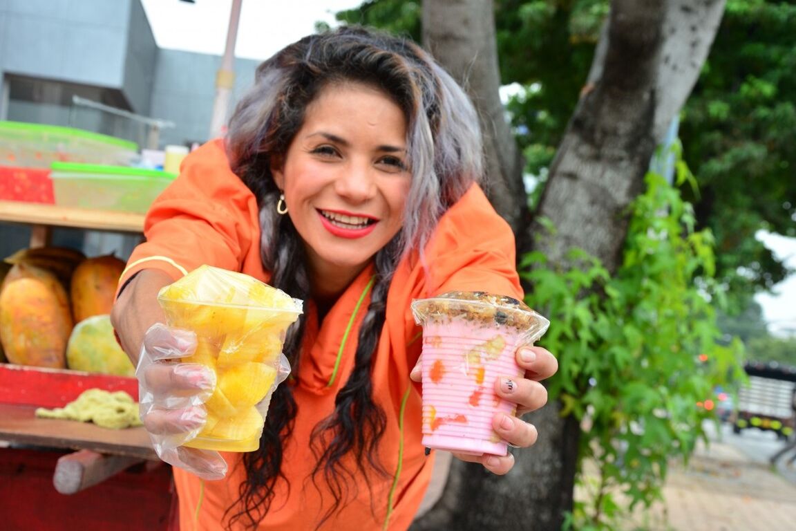17P Beautiful Colombian fruit seller gestures provocatively with a banana