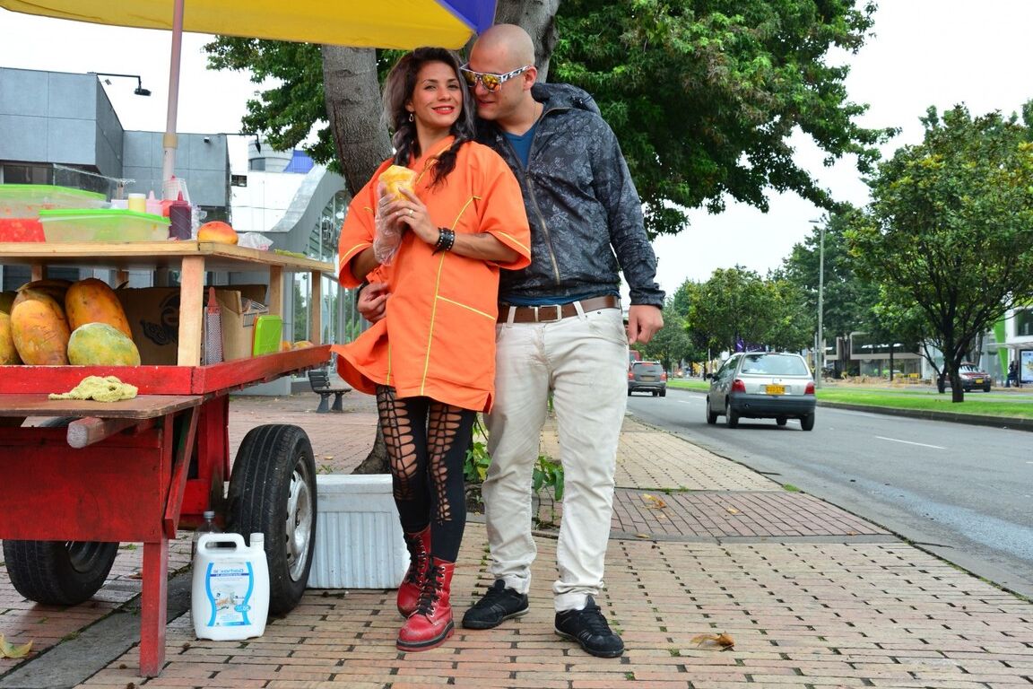 17P Beautiful Colombian fruit seller gestures provocatively with a banana