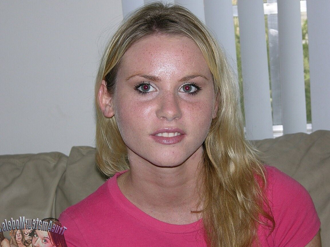 15P Rubia sexy amateur se acurruca desnuda en su cama mostrando su coño adolescente hinchado
