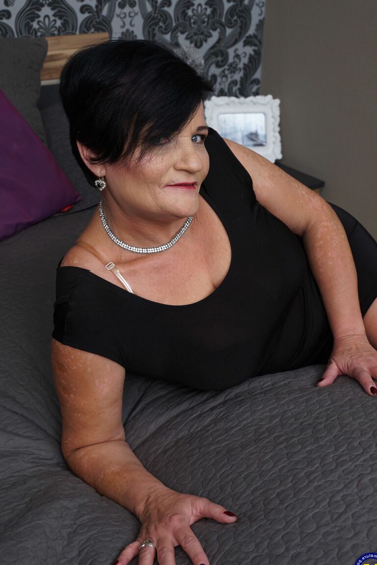 21P Dark haired mature with big juggs Freya rides a stiff rod on a bed