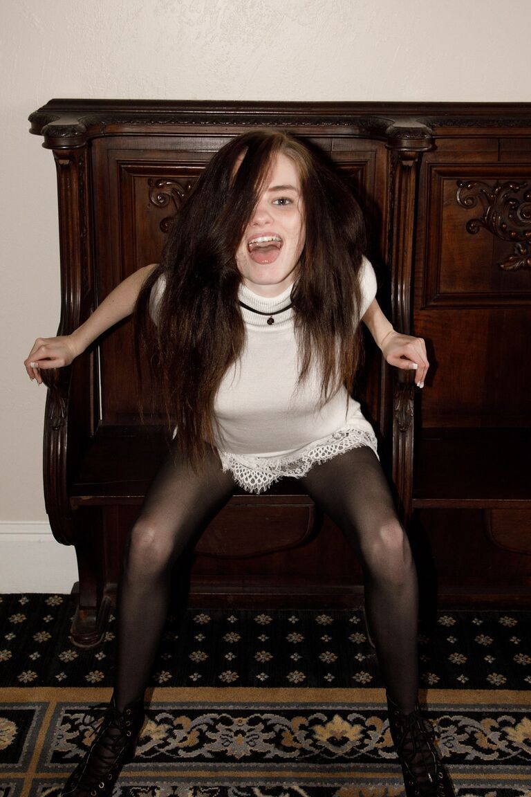 12P La grande adolescente Lanah Adams enlève ses collants pour montrer une jupe haute.