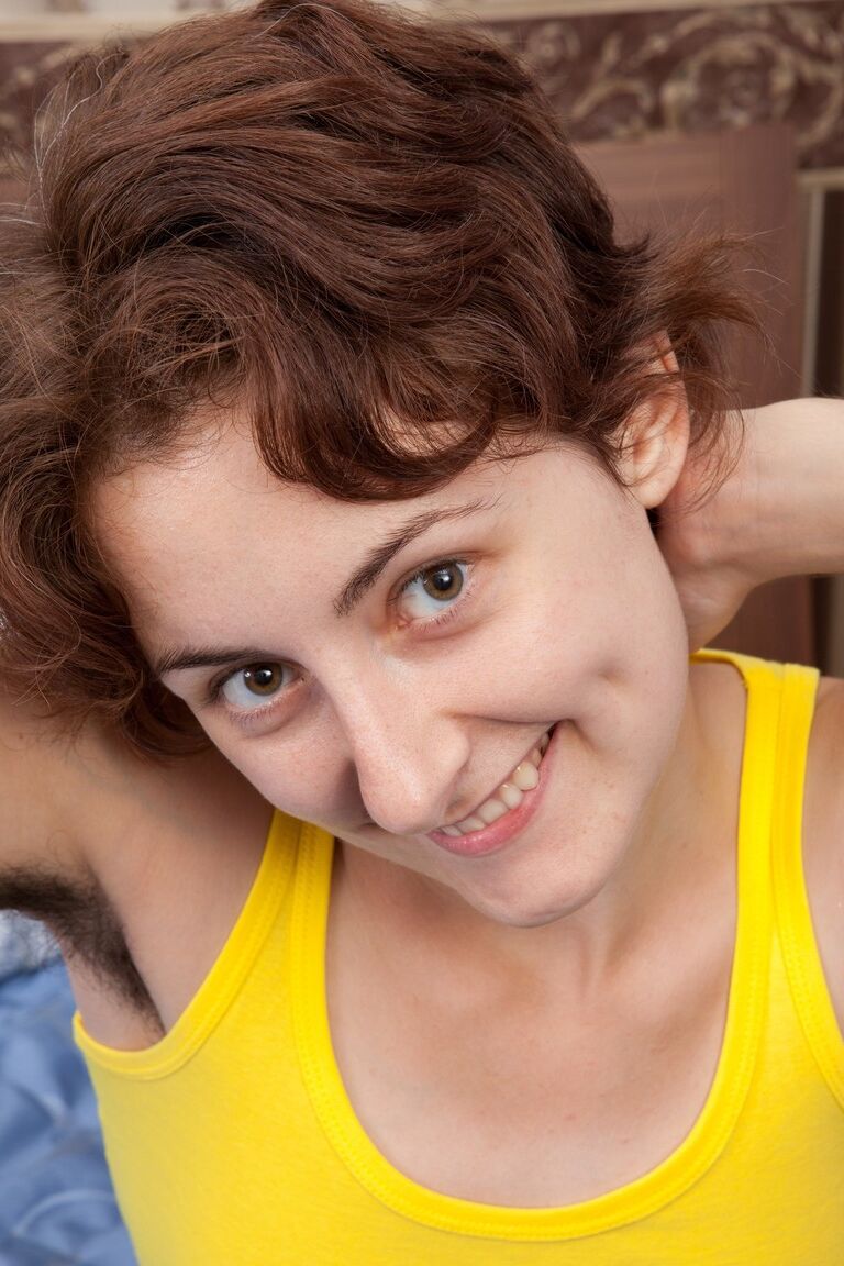 18P Garota excitada Alisa revela seus seios minúsculos e regalo peludo em uma cama