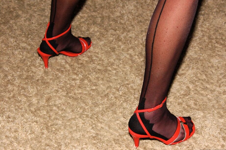15P Older lady models lingerie and hosiery in long boots and high heeled shoes
