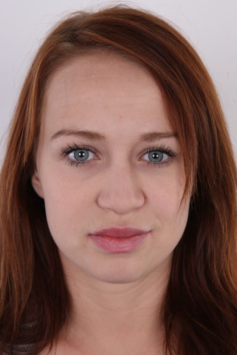 20P Natural redhead Dominika models clothed before standing totally naked