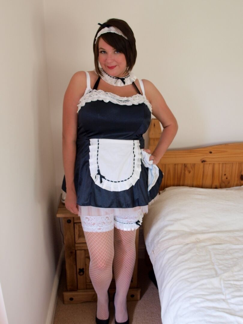 17P Brunette maid Roxy loose her large breasts on a bed while at work
