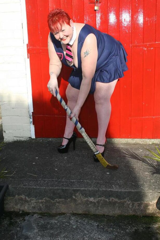 20P Mature redheaded wields a field hockey stick while exposing herself outdoors
