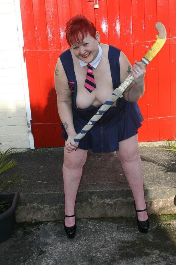 20P Mature redheaded wields a field hockey stick while exposing herself outdoors