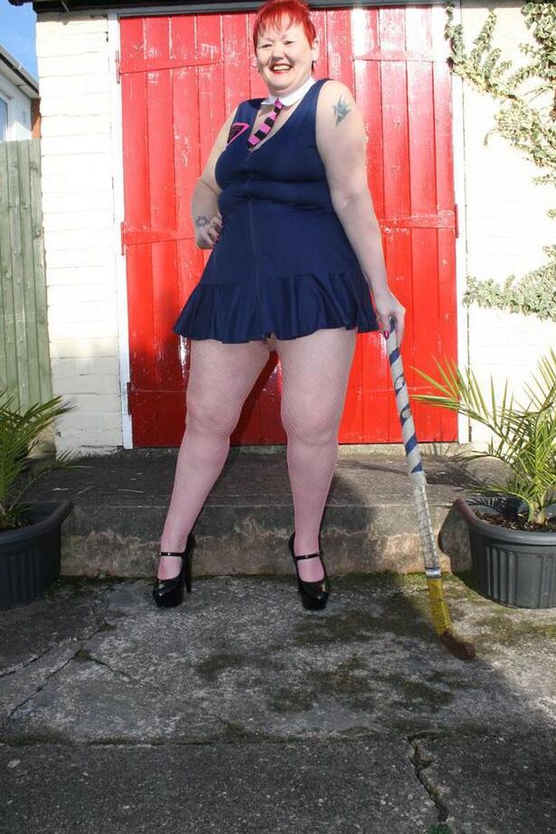 20P Mature redheaded wields a field hockey stick while exposing herself outdoors