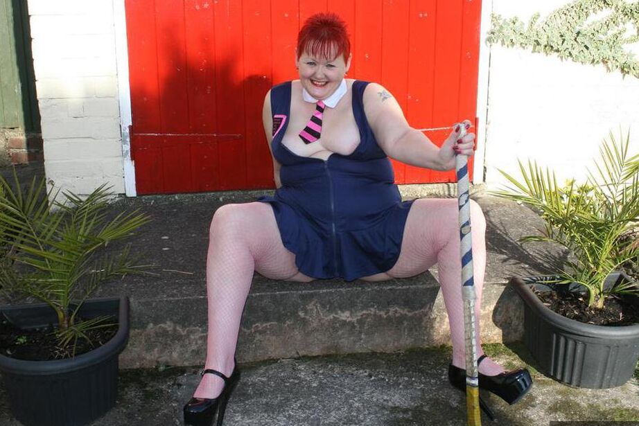 20P Mature redheaded wields a field hockey stick while exposing herself outdoors