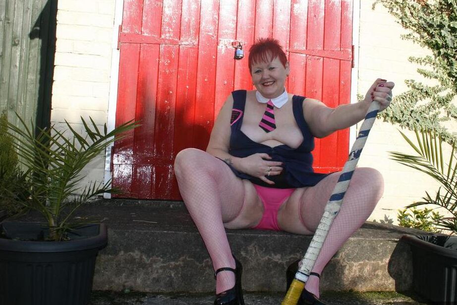 20P Mature redheaded wields a field hockey stick while exposing herself outdoors