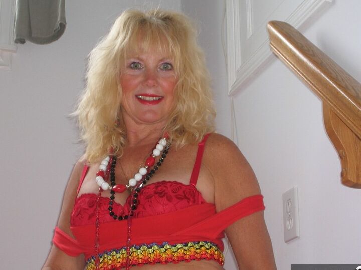 20P Aged blonde amateur Ruth goes topless in a mirror while wearing stripper boots