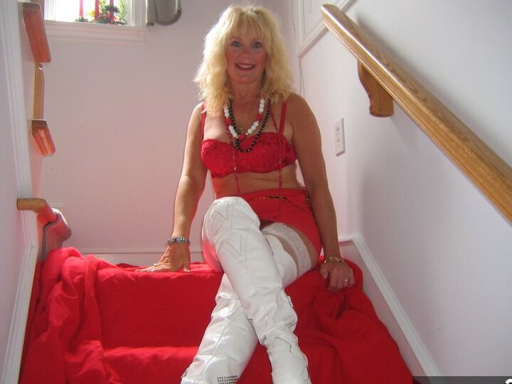 20P Aged blonde amateur Ruth goes topless in a mirror while wearing stripper boots