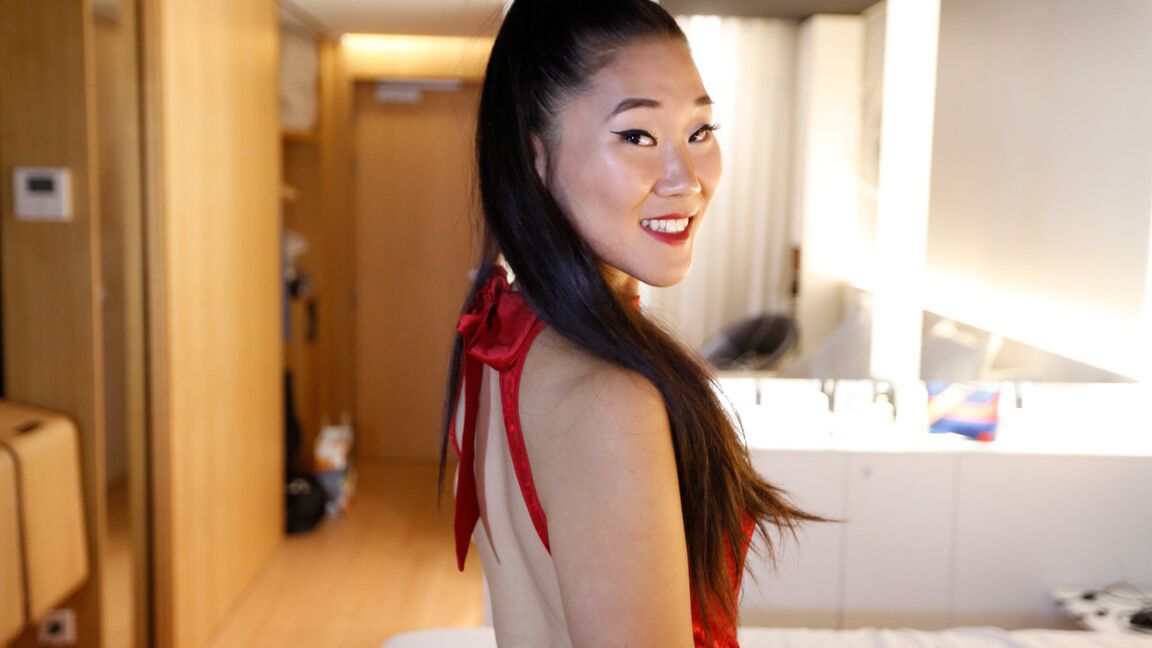 15P Asian chick in a black miniskirt gets undressed before POV sex on a bed