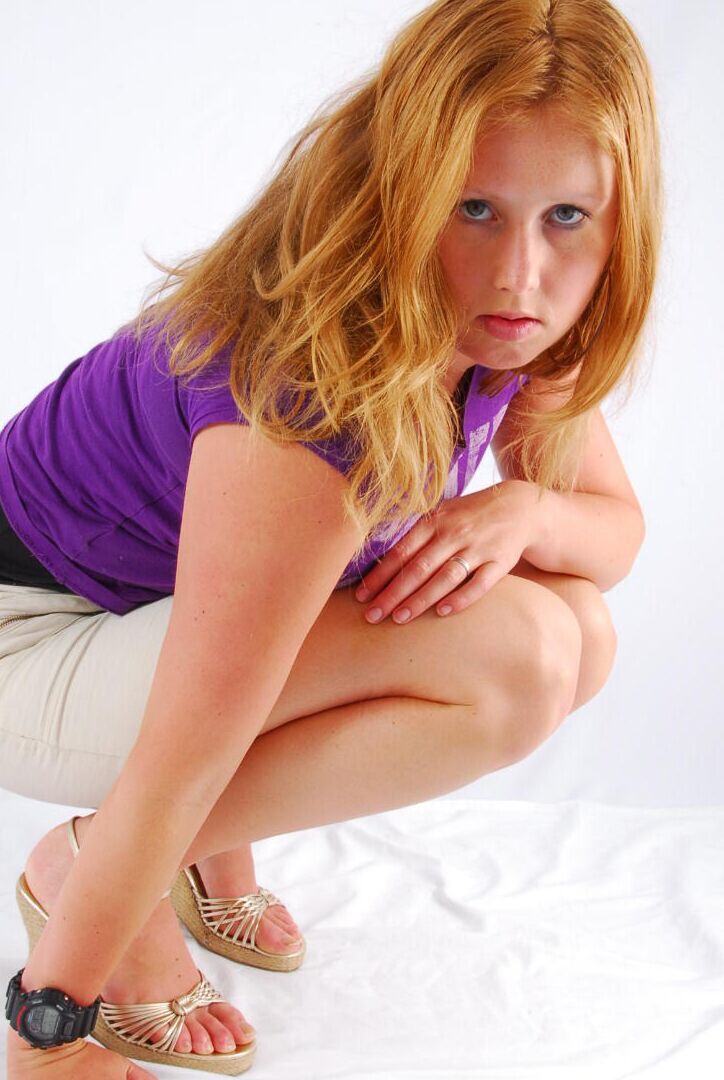 16P Natural redhead Judy models a black G-Shock watch while fully clothed