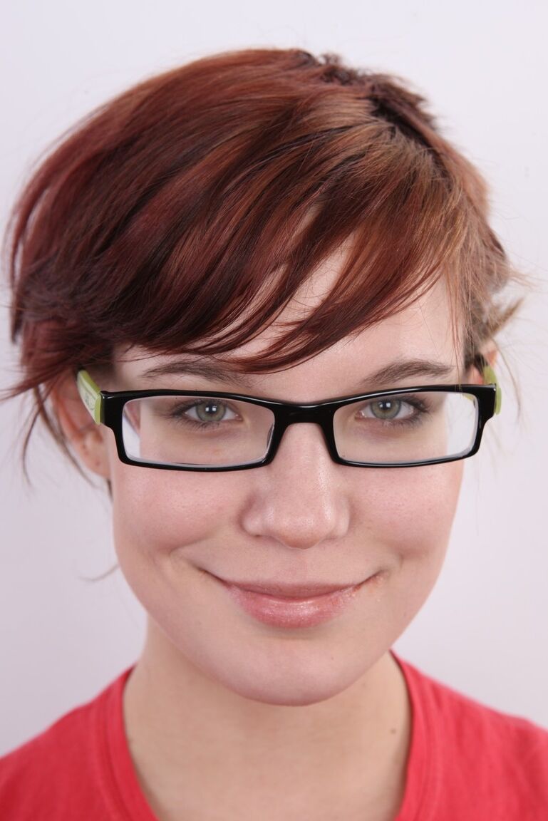 20P Nerdy redhead wears a mischievous smile while getting naked for the first time