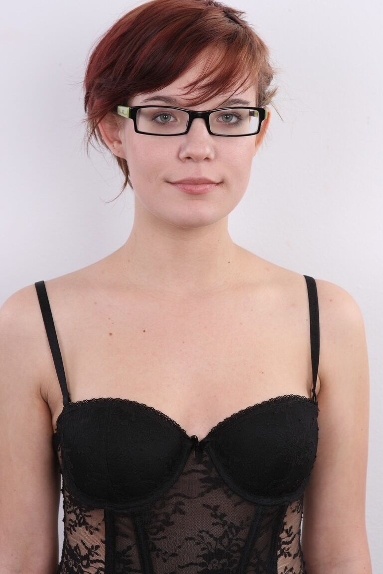20P Nerdy redhead wears a mischievous smile while getting naked for the first time