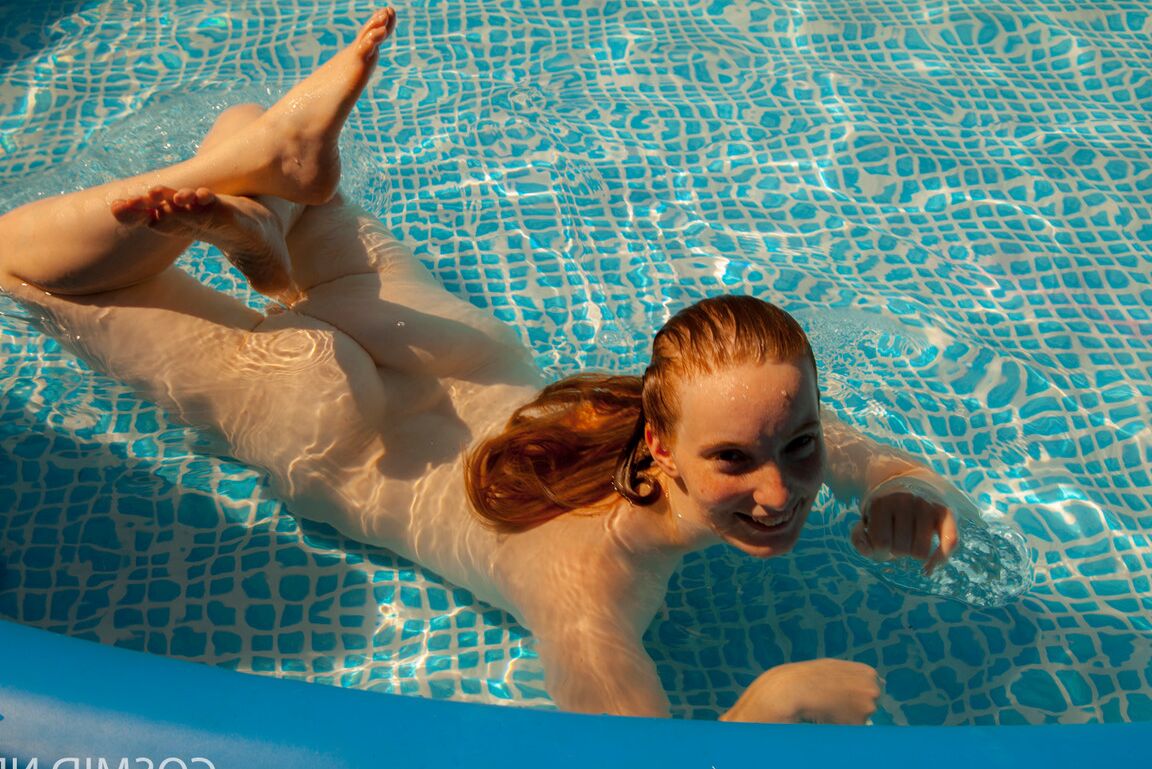 16P Natural redhead Julia Fleming frees her big natural tits in above ground pool