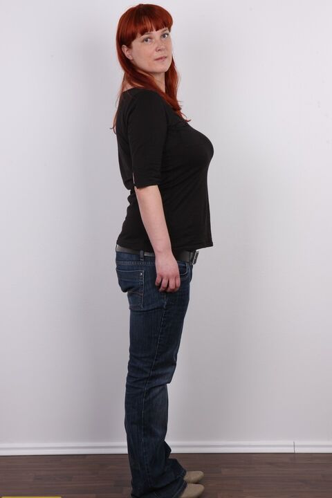 20P Redhead plumper Maja takes a seat after stripping naked afore a wall