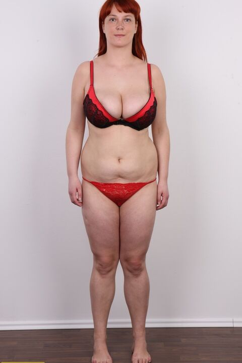 20P Redhead plumper Maja takes a seat after stripping naked afore a wall