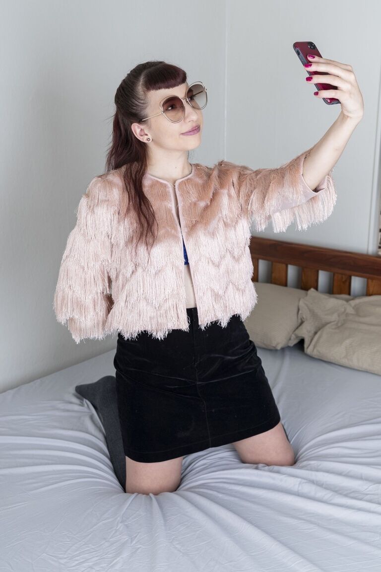 21P Small-titted babe Calliope probing her hairy pussy with a finger up close