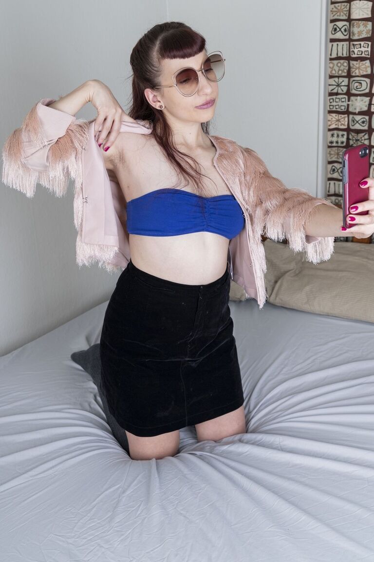 21P Small-titted babe Calliope probing her hairy pussy with a finger up close