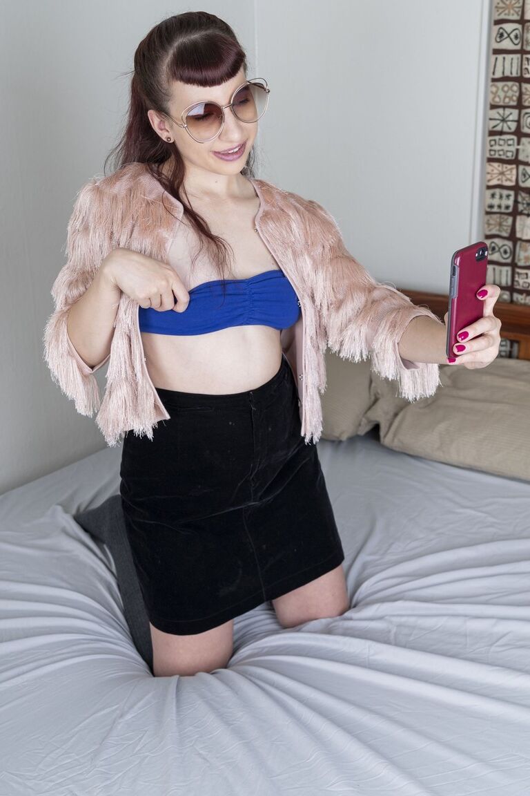21P Small-titted babe Calliope probing her hairy pussy with a finger up close