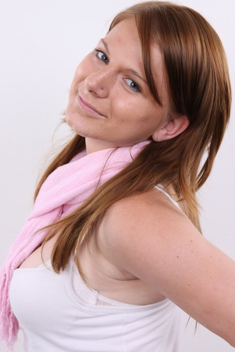 20P Redhead amateur Sabrina stands naked with hands on hips during a solo gig