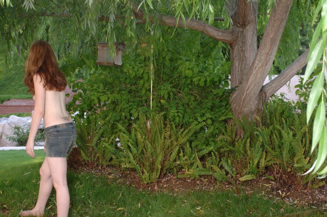 16P Redhead amateur Ruby Flame sports a close-up of her bald pussy in the yard