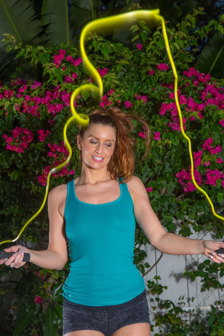 16P Redhead amateur April Sutton skips rope before disrobing afore rose bushes