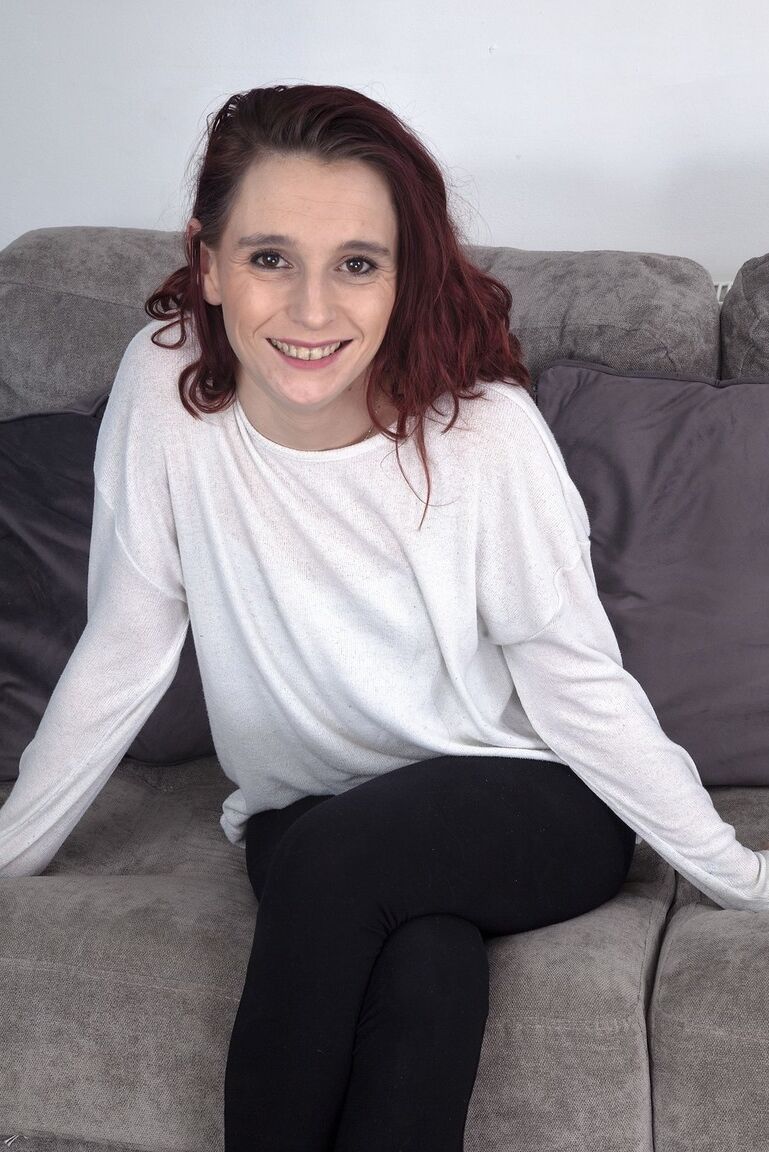 16P Flexible UK redhead Lily May shows her hairy armpits and muff on a sofa