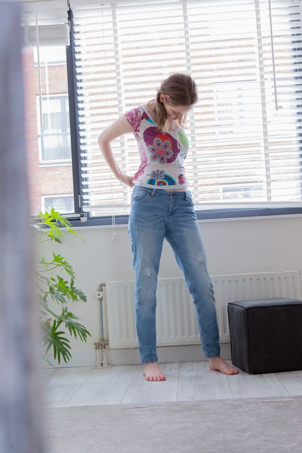 16P Hidden spy camera captures a solo girl pulling on her panties and blue jeans