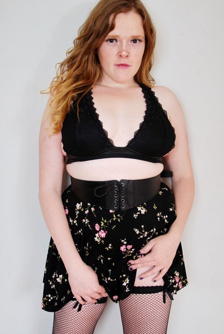 16P Natural redhead uncups her small tits while wearing back seem nylons