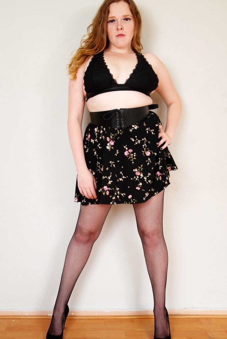 16P Natural redhead uncups her small tits while wearing back seem nylons