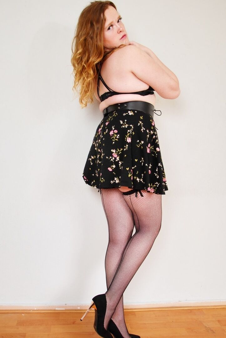 16P Natural redhead uncups her small tits while wearing back seem nylons