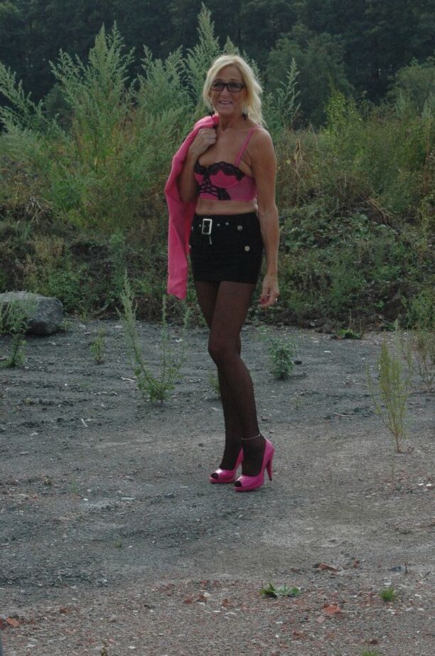 20P Tall blonde wanders around vacant land in crotchless hose and miniskirt