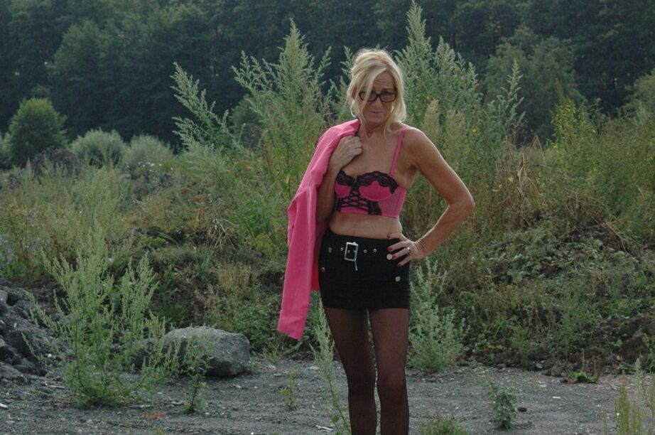 20P Tall blonde wanders around vacant land in crotchless hose and miniskirt