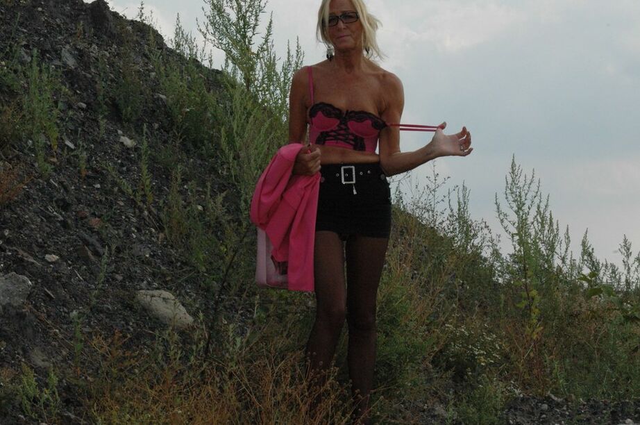 20P Tall blonde wanders around vacant land in crotchless hose and miniskirt