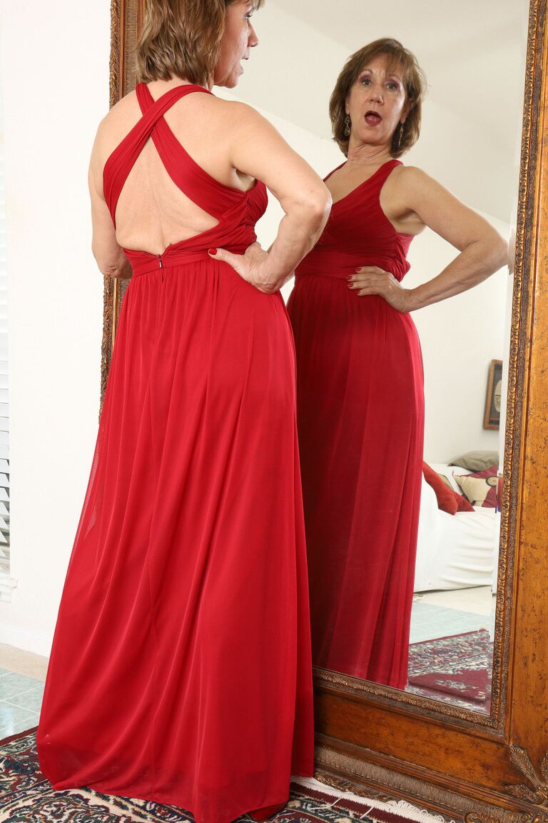 16P 30 plus redhead Lynn doffs a long red dress before pussy play afore a mirror