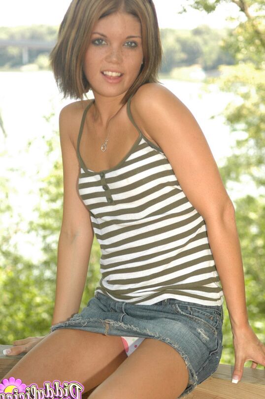 12P Petite teen Diddylicious hikes a denim miniskirt over a thong on a deck